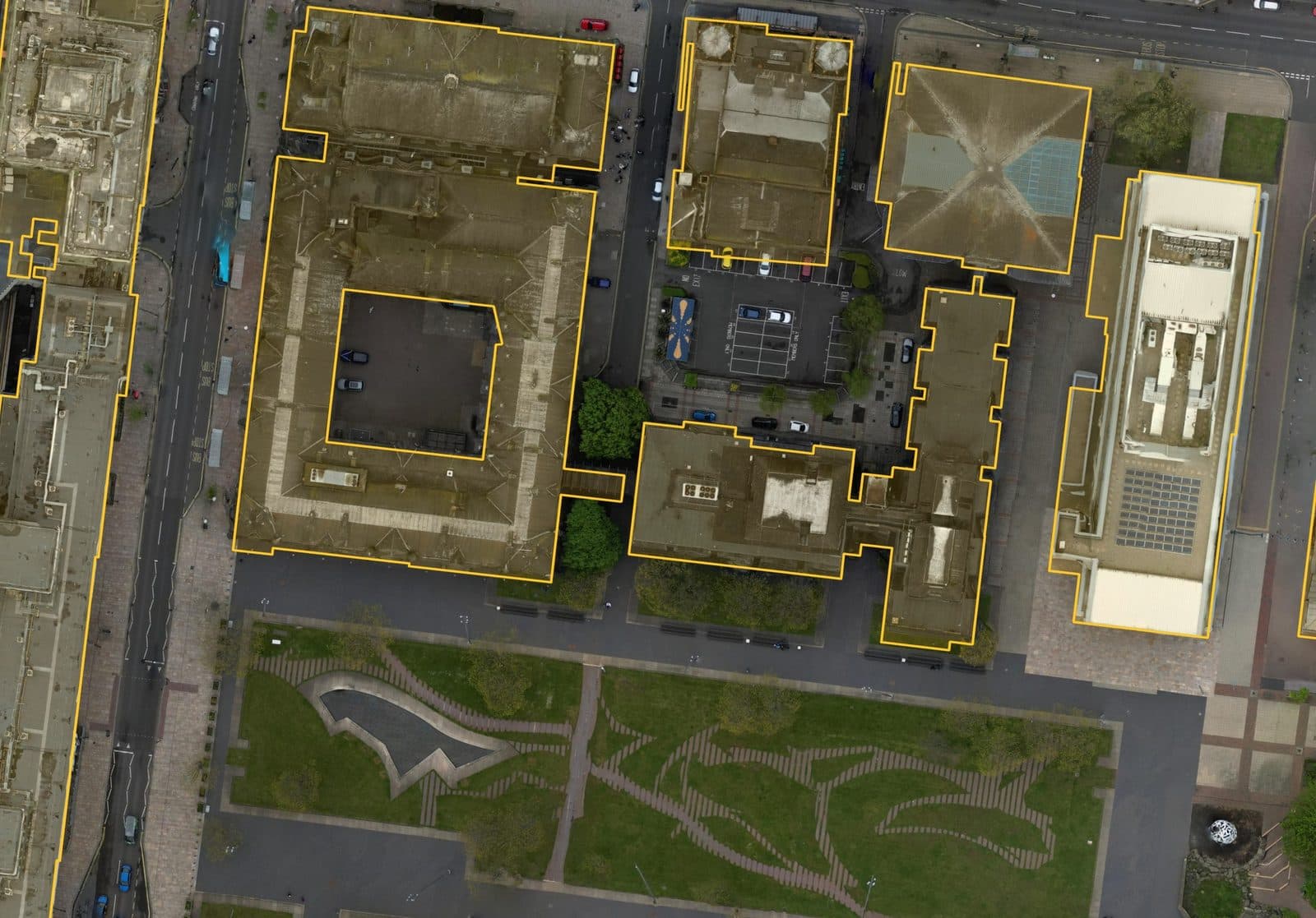 Aerial photo of a town hall and neighbouring civic buildings, roofs outlined in amber with the courtyard left open.